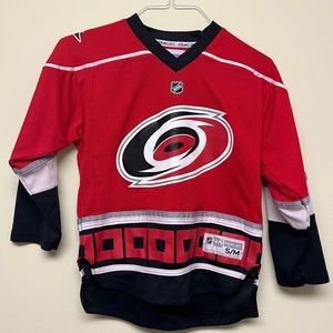 Show your team pride with this hardly worn Carolina Hurricane youth jersey.